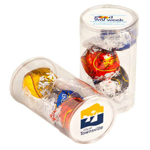 Three Lindt chocolate balls in a clear tube with decorative filler, featuring a logo on the base. Pet Tube with Lindt Balls x3 - Image 1
