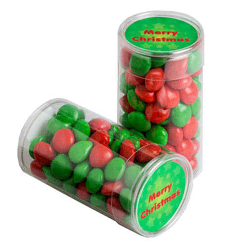 Two clear tubes filled with red and green chewy fruits, themed for Christmas. The tubes feature a logo or branding. PET Tube with CHRISTMAS CHEWY Fruits 100g - Image 1
