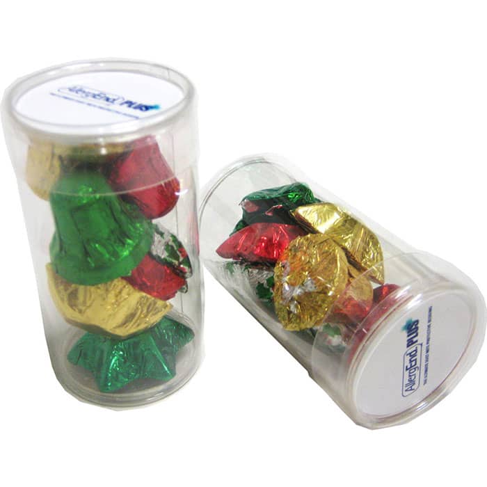A clear tube filled with wrapped chocolates in red, green, and gold shapes resembling Christmas bells. PET Tube filled with CHRISTMAS Chocolates 55g - Image 1
