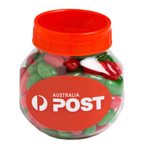 A clear plastic jar filled with red, white, and green jelly beans, topped with an orange lid. Plastic Jar filled with CHRISTMAS Jelly Beans 170g - Image 1
