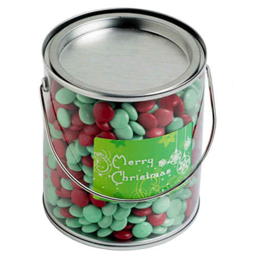 A metal bucket filled with red and green chocolate beans, featuring a festive label on the front. Big PVC Bucket with Christmas Choc Beans 875G - Image 1