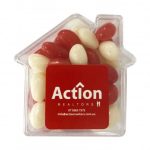 Acrylic house-shaped container filled with red and white jelly beans, featuring a logo on the front.