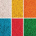 A collection of brightly coloured chewy fruit candies in six sections: white, yellow, orange, red, blue, and green.