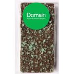 Premium chocolate bar with green peppermint crystals on top, wrapped in clear packaging and featuring a round logo.