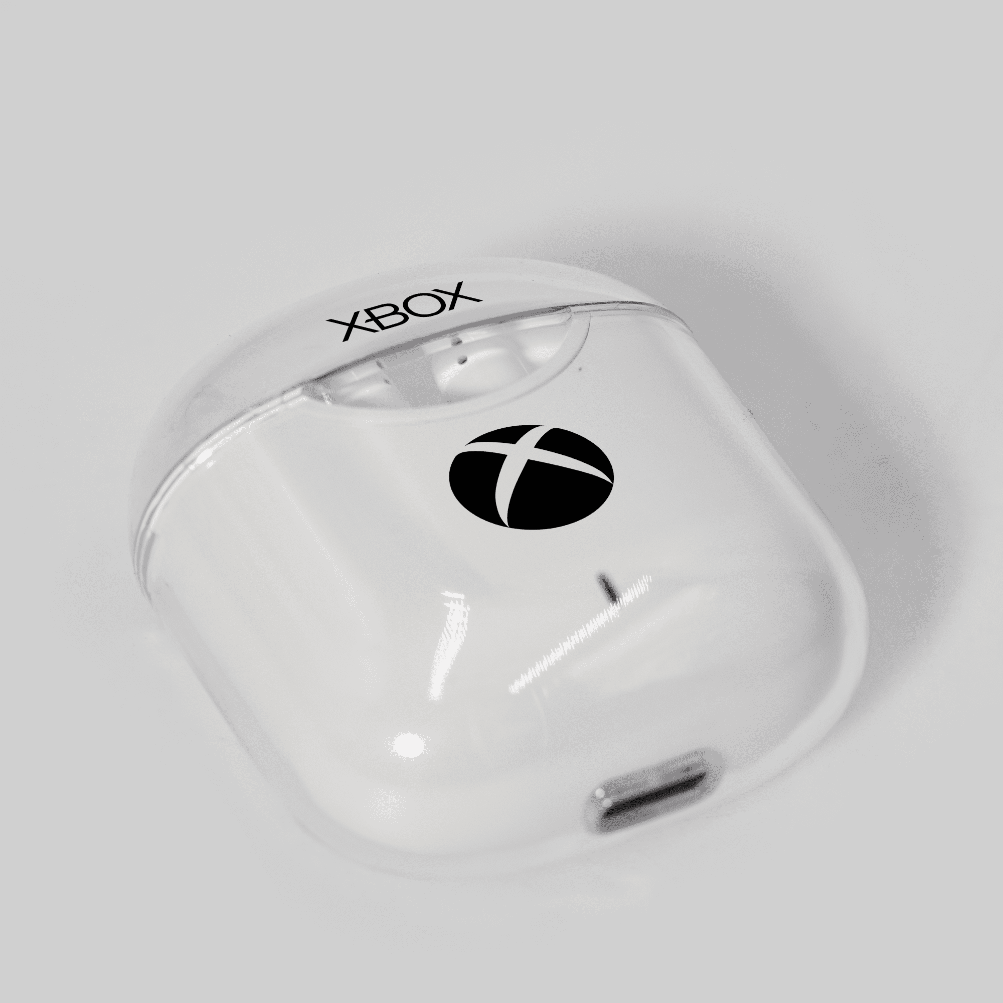 A pair of white earphones in a clear case, featuring a logo on the front. Clarity BT Noise Cancellation Earphone - Image 1