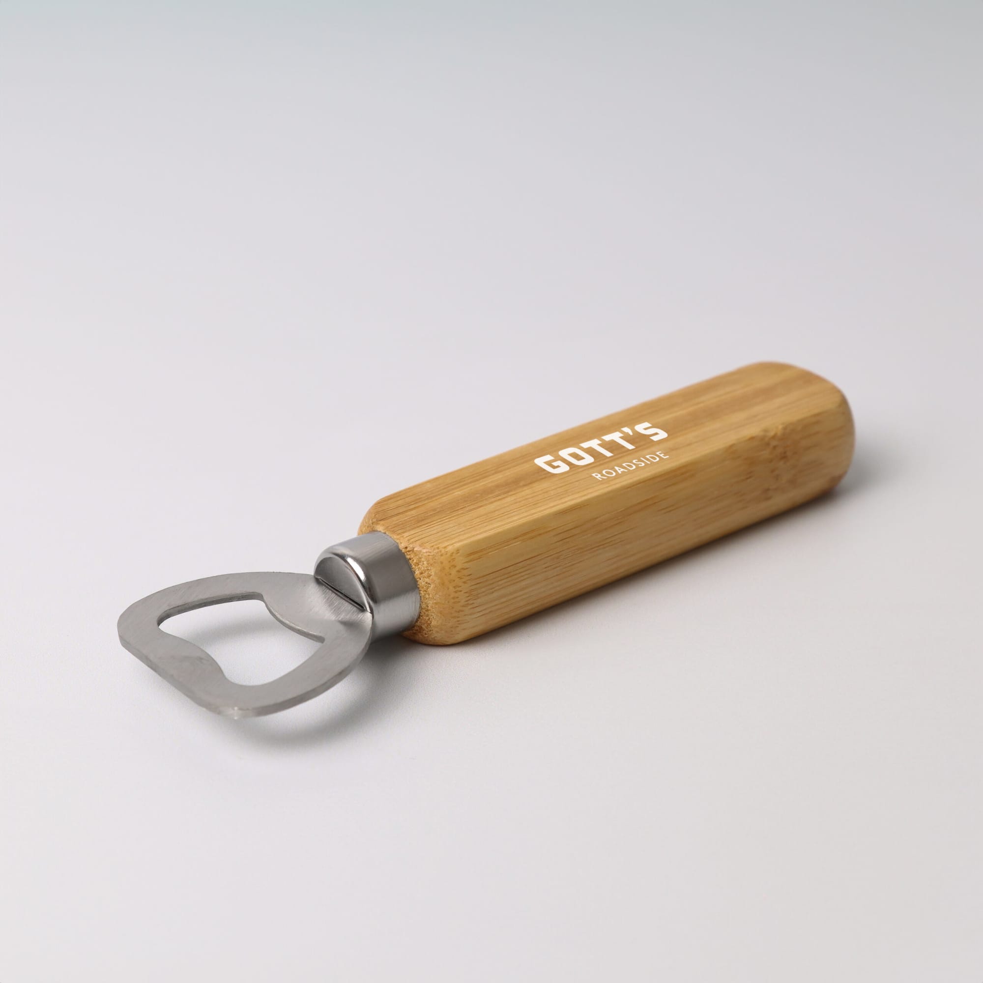A bamboo bottle opener with a stainless steel opening end and a smooth wooden handle, featuring a logo. Bamboo Bottle Opener - Image 1