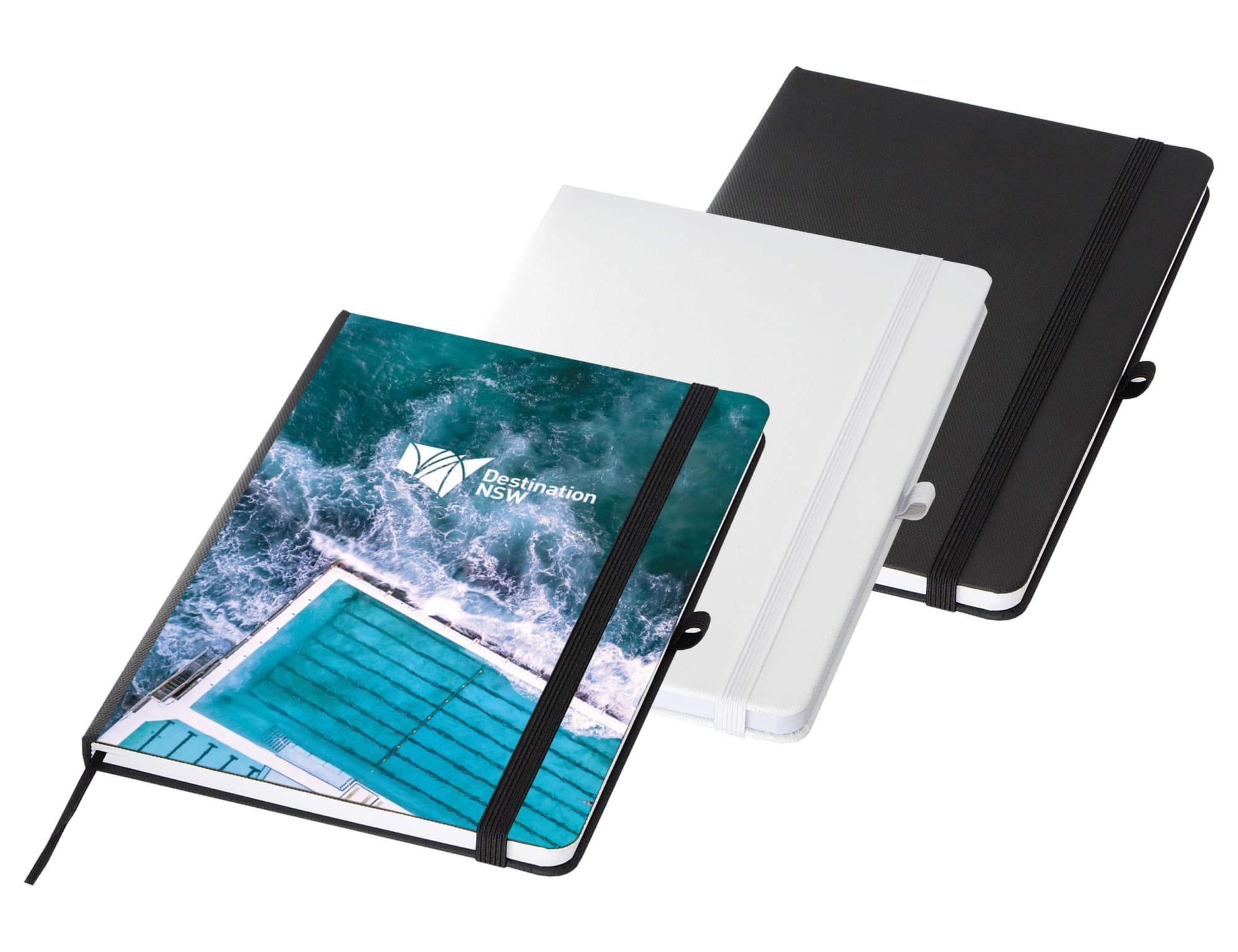 A set of three A5 notebooks in black, white, and a design featuring a blue swimming pool, with an elastic band closure. Bio rPET Dot Grid A5 Notebook - Image 1
