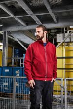 A red doubleface jacket is displayed on a model in a work environment, showcasing its practical design.