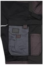 Close-up of black workwear stretch-pants featuring grey pockets and a branded label.