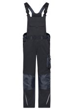 Workwear pants with bib in navy blue, featuring adjustable straps, multiple pockets, and reinforced knees. Includes branding.
