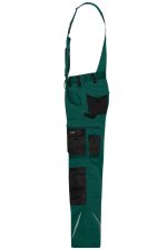 Workwear pants with bib in green featuring black accents and multiple pockets, designed for durability and function.