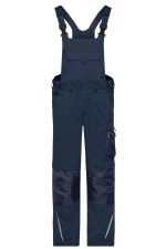 Navy workwear pants with bib design, featuring adjustable straps and pockets, suitable for rugged use.