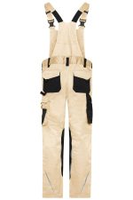 Workwear pants with bib in a beige colour, featuring black accents and multiple pockets. Includes adjustable straps and a branding logo.