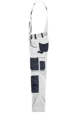 Workwear pants with bib in white and navy, featuring multiple pockets and a strap for additional support.