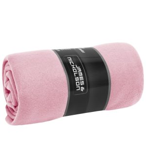 A rolled pink fleece blanket with a black label featuring a logo.