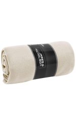 A rolled fleece blanket in a soft cream colour, featuring a branded label.