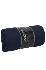 A rolled navy fleece blanket with a label featuring branding on a neutral background.