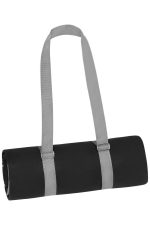 A rolled black picnic blanket secured with grey straps, featuring a logo on the side.