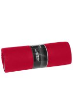 A rolled red picnic blanket with a black label. The blanket is smooth and neatly folded for storage.