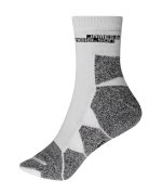 A pair of white sport socks with grey patterns and a logo on the cuff.
