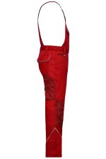 A pair of red workwear pants with bib and adjustable straps, featuring multiple pockets and a logo.