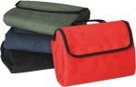 A red picnic blanket with black trim, alongside green, navy, and black folded blankets. Each has a handle for easy carrying.