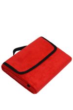 A red picnic blanket folded with a black trim and strap for easy carrying.