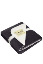 A folded black and white blanket with a soft, fluffy interior, neatly tied with a ribbon and featuring a label.