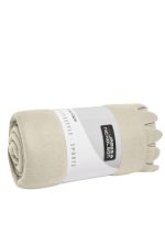 A rolled beige fleece blanket with a branded label, featuring a soft texture and neat edges.