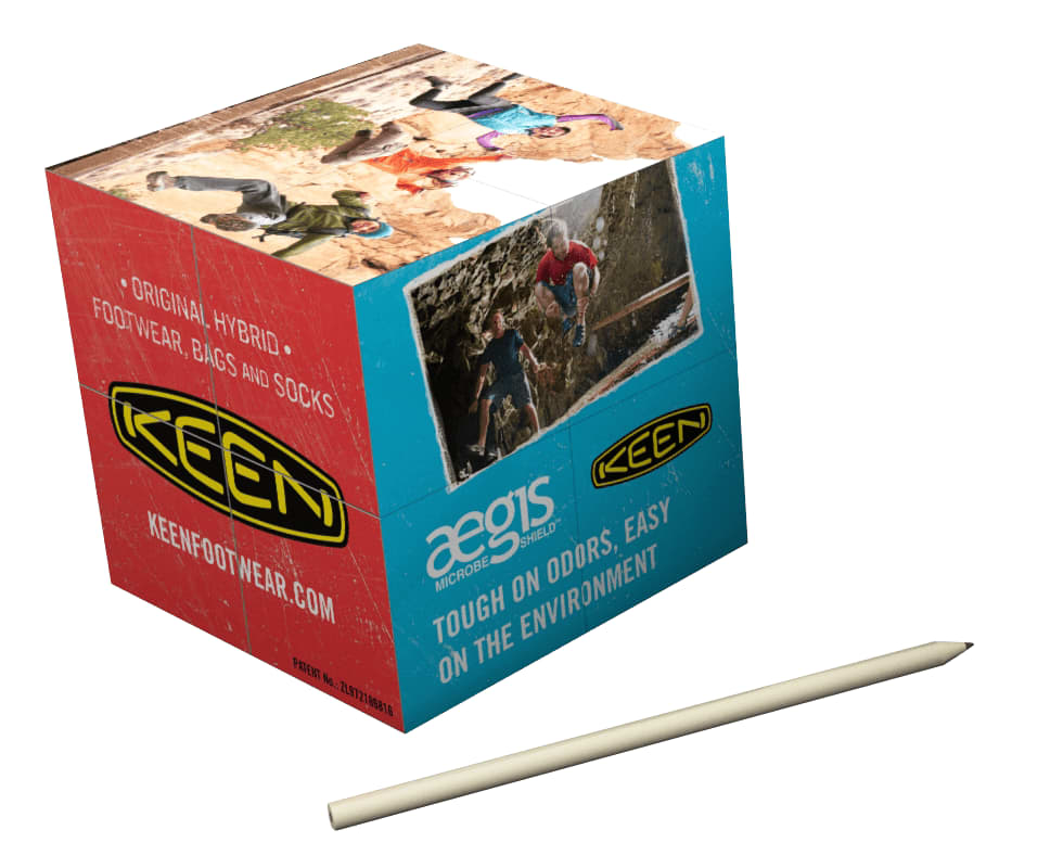 A red and blue promotional box for a product named "12cm Mega Magic Cube" with a logo and images of outdoor activities. 12cm Mega Magic Cube - Image 1