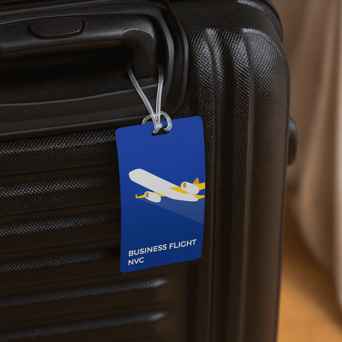 A blue imprinted large luggage tag attached to a black suitcase handle, featuring a graphic of an airplane. Imprinted Large Luggage Tag - Image 1