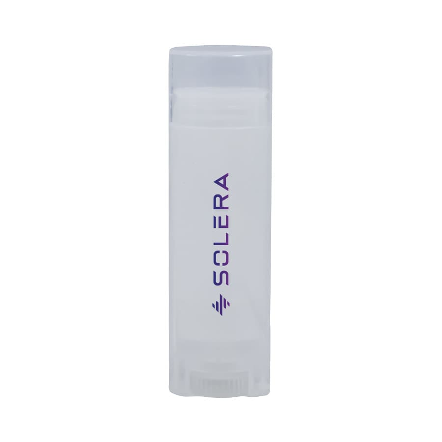 A transparent lip balm container with a white balm inside and a purple logo. Coconut Lip Balm - Image 1