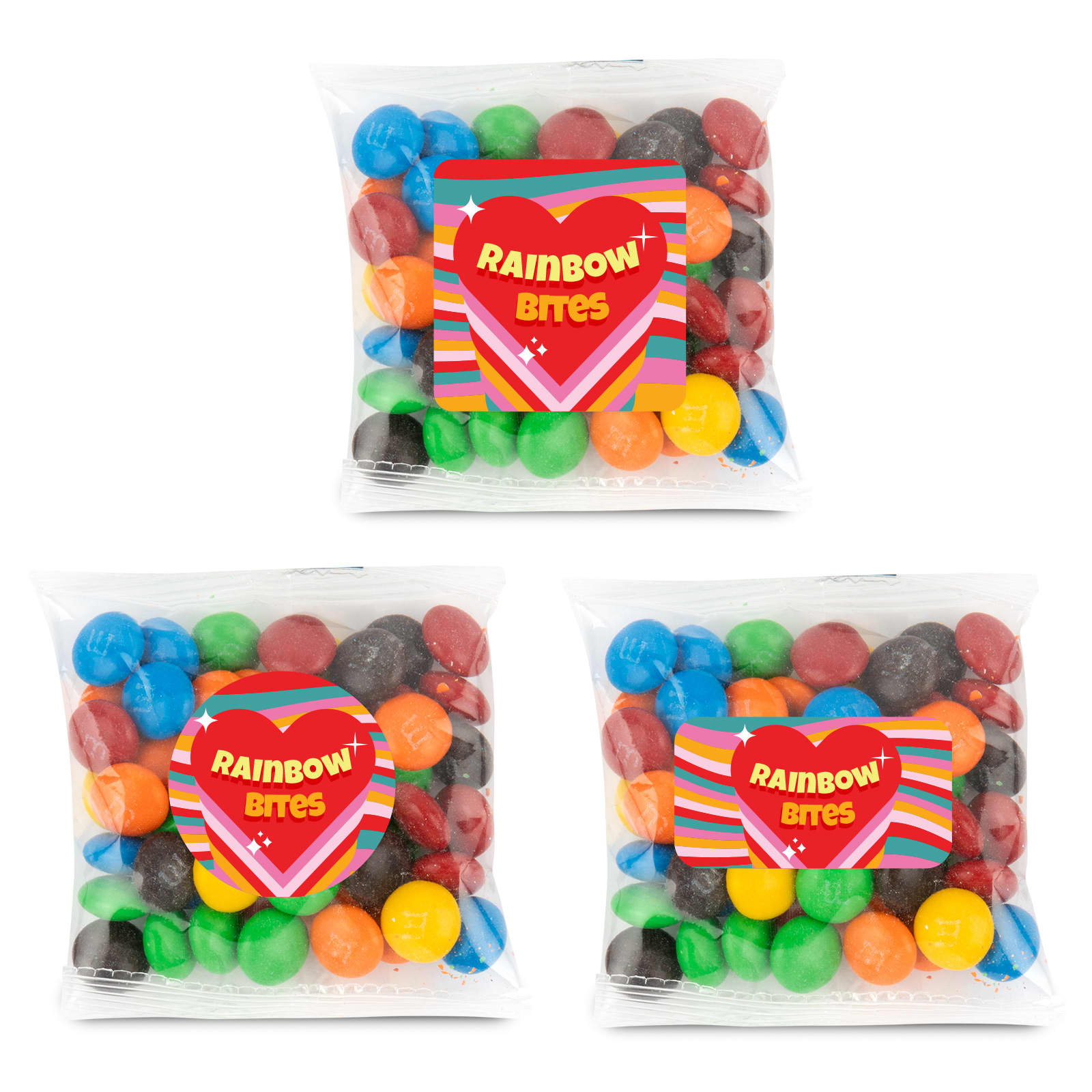 Three clear cello bags containing colorful chocolate-coated candies in various hues, including red, green, blue, and yellow. M&M's in 50 Gram Cello Bag - Image 1