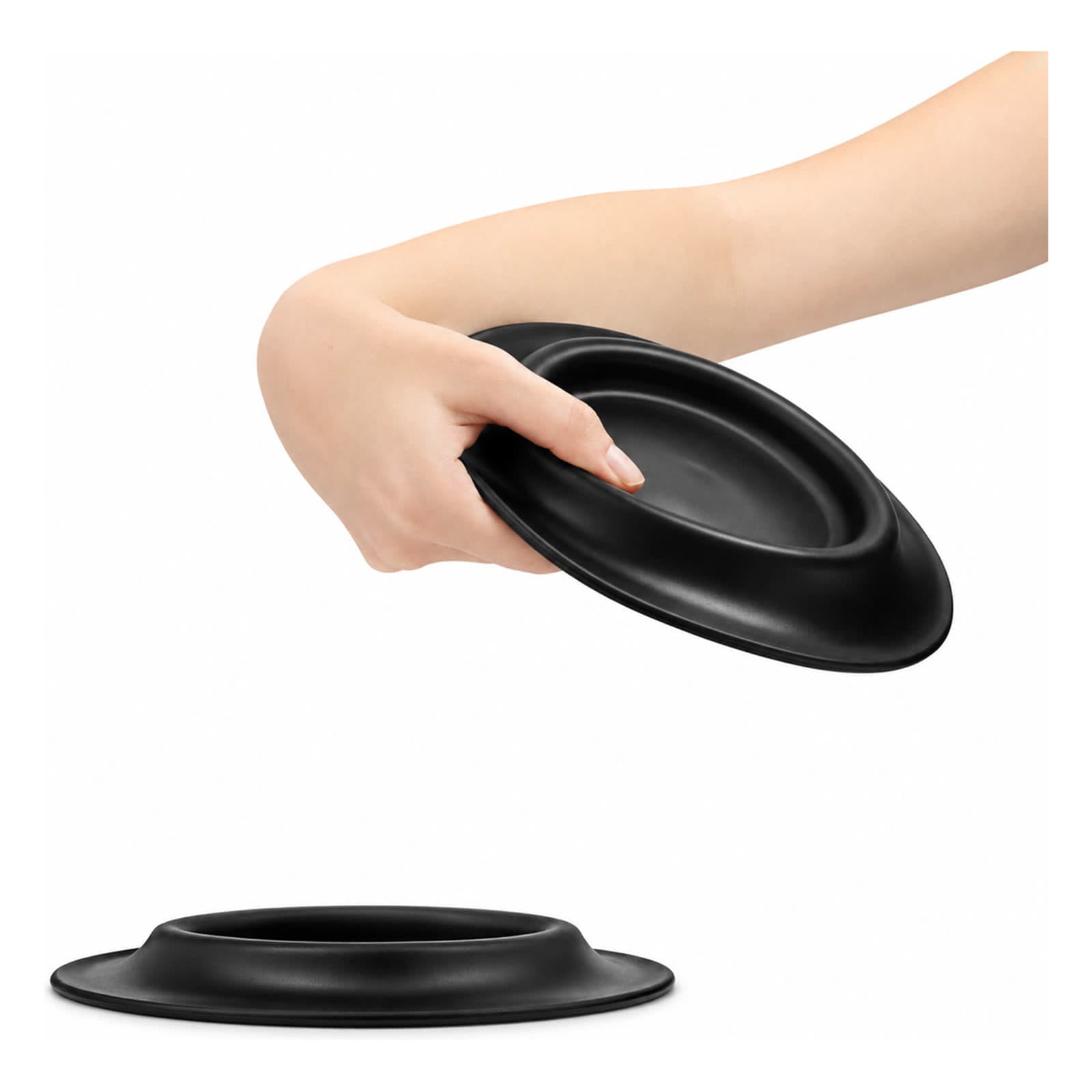 A black pet bowl with a raised edge, held by a hand. The bowl appears sleek and smooth. Sip n Fly Pet Bowl - Image 1