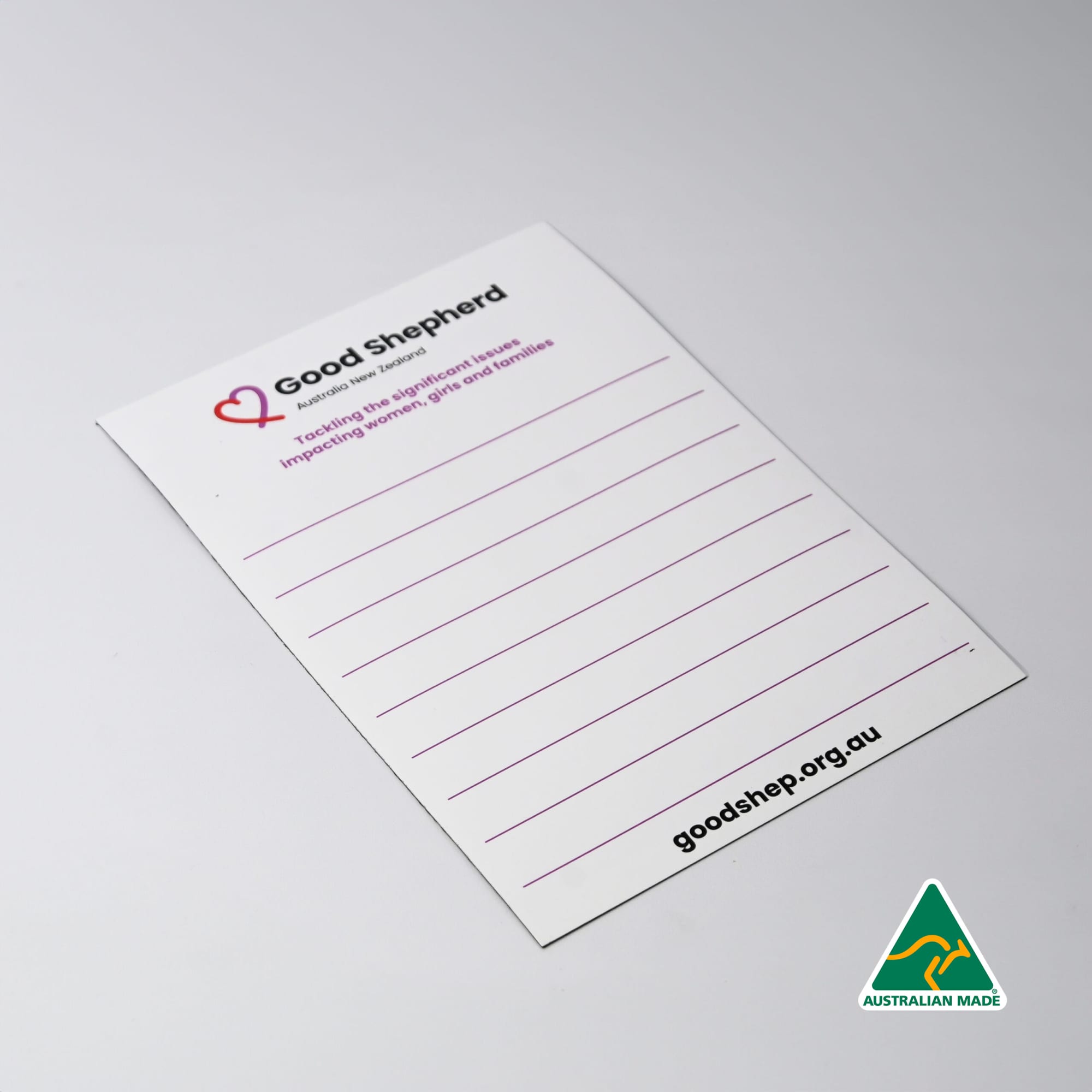 A white magnetic whiteboard featuring lined sections and a logo in the corner. It has a smooth, glossy finish. Magnetic Whiteboard (148mm x 210mm) - Image 1