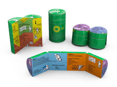 A green promotional product with a cylindrical shape, featuring colourful panels with illustrations and a logo. Magic Can - Image 1