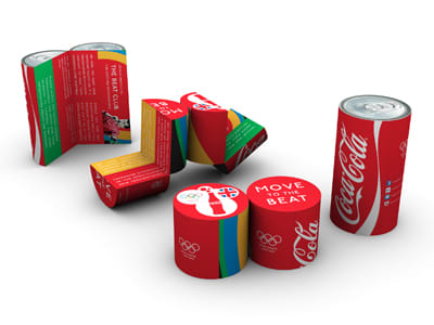 A collection of colourful drink cans and packaging featuring a mix of designs and a logo. The colours include red, green, and yellow. Magic Can Mini - Image 1