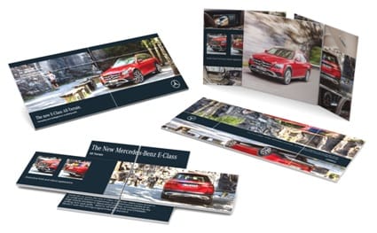 A promotional brochure featuring a red Mercedes-Benz E-Class, showcasing images and information about the vehicle. Magic Card 210 - Image 1