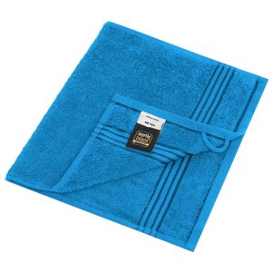 A blue hand towel with a textured surface and striped design, featuring a label and a hanging loop.