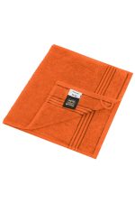 An orange hand towel featuring a textured surface and a folded corner with a brand label.