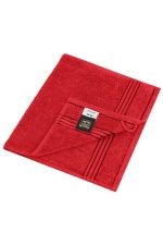 A red guest towel with a textured surface and a folded corner featuring a tag, showcasing a simple design.