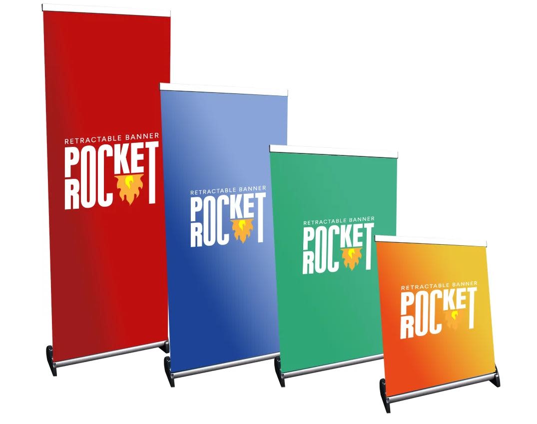 A set of four retractable banners in red, blue, green, and white, each with a logo. Banners vary in height. Mini Pull Up Banner 400mm x 400mm - Image 1