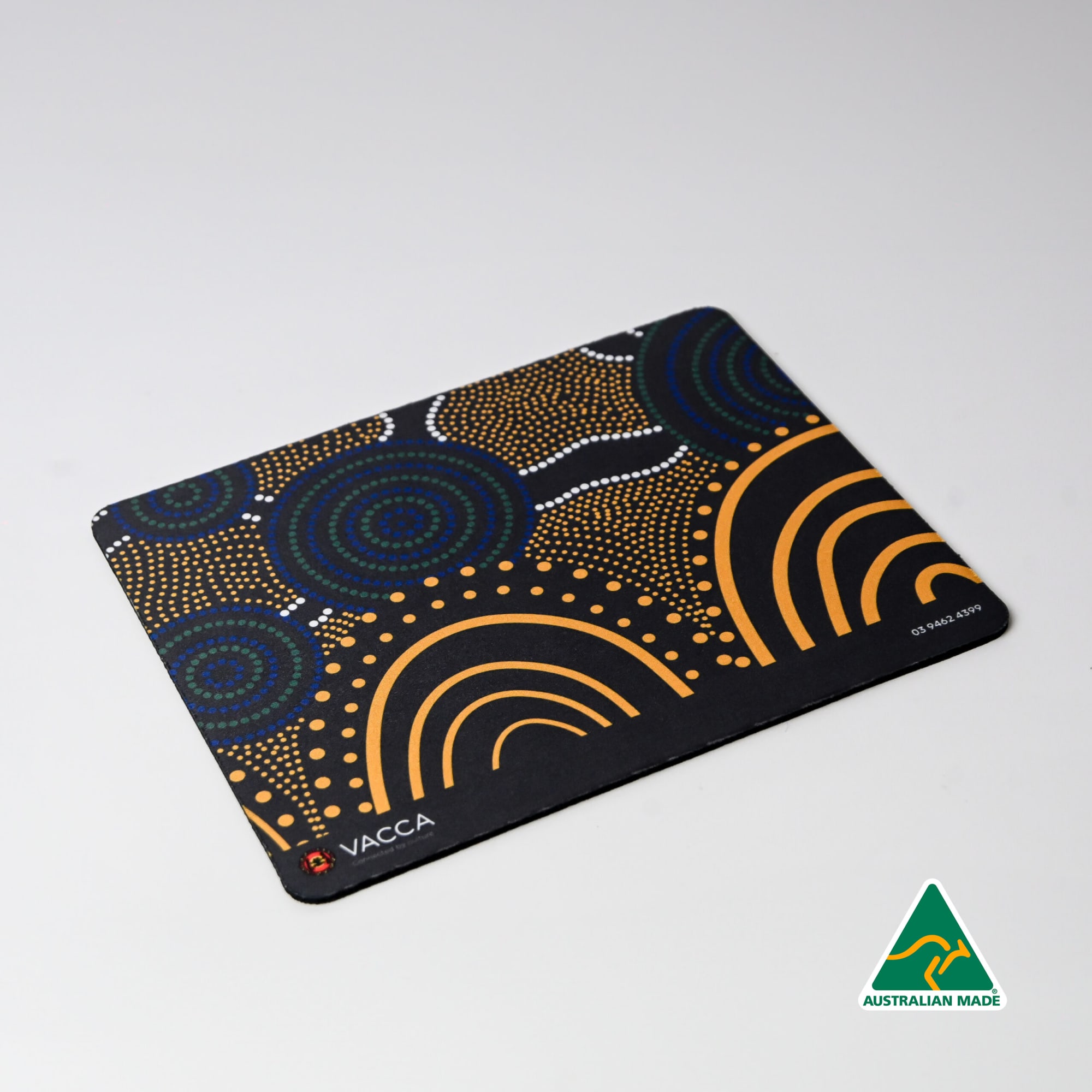 A mouse mat featuring an indigenous-inspired design with vibrant patterns in blue, orange, and white. It has a logo. Deluxe Mouse Mat (230mm x 190mm) - Image 1