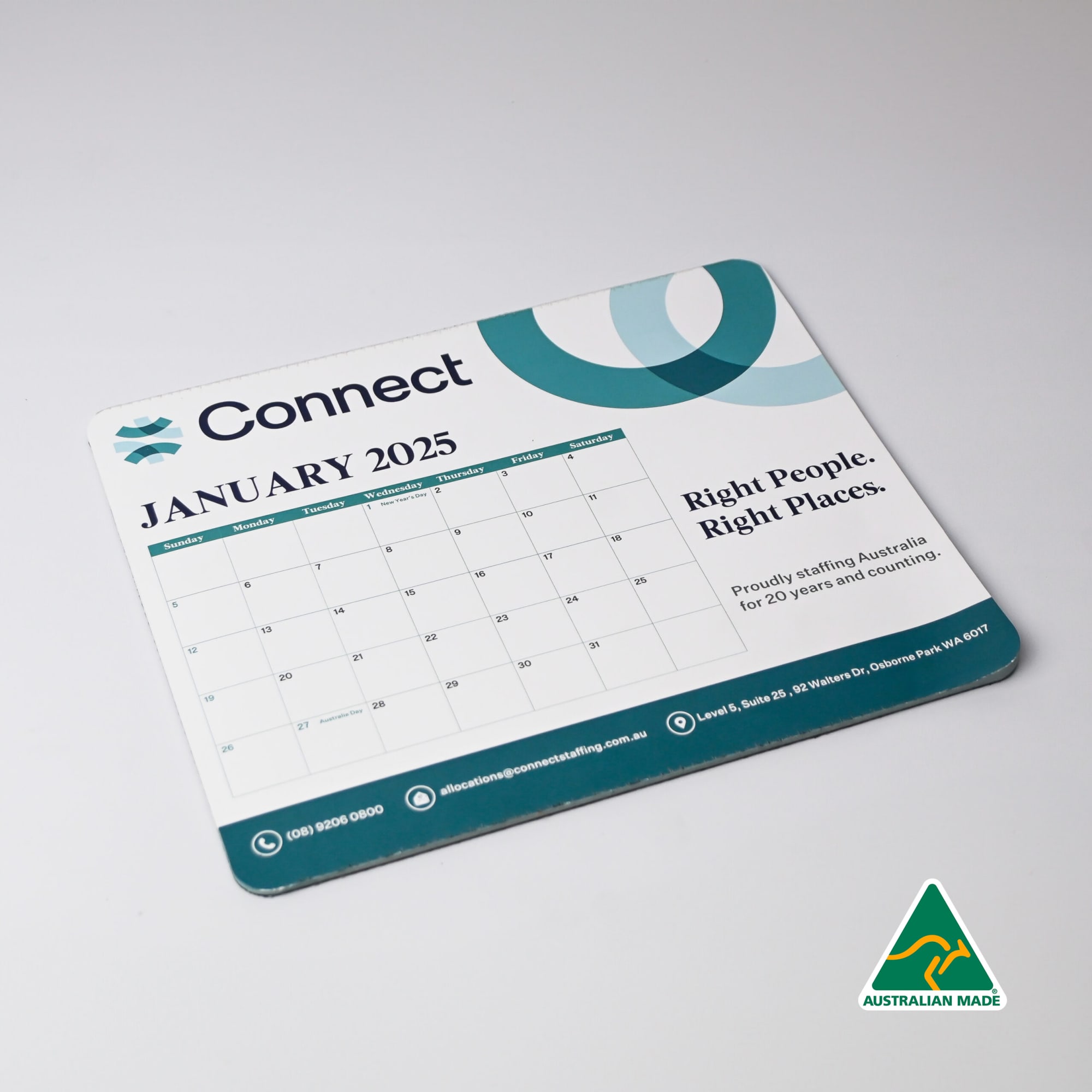 A mouse mat featuring a calendar for January 2025, in blue and green tones, with a logo and Australian-made badge. Calendar Mouse Mat (230mm x 190mm) - Image 1