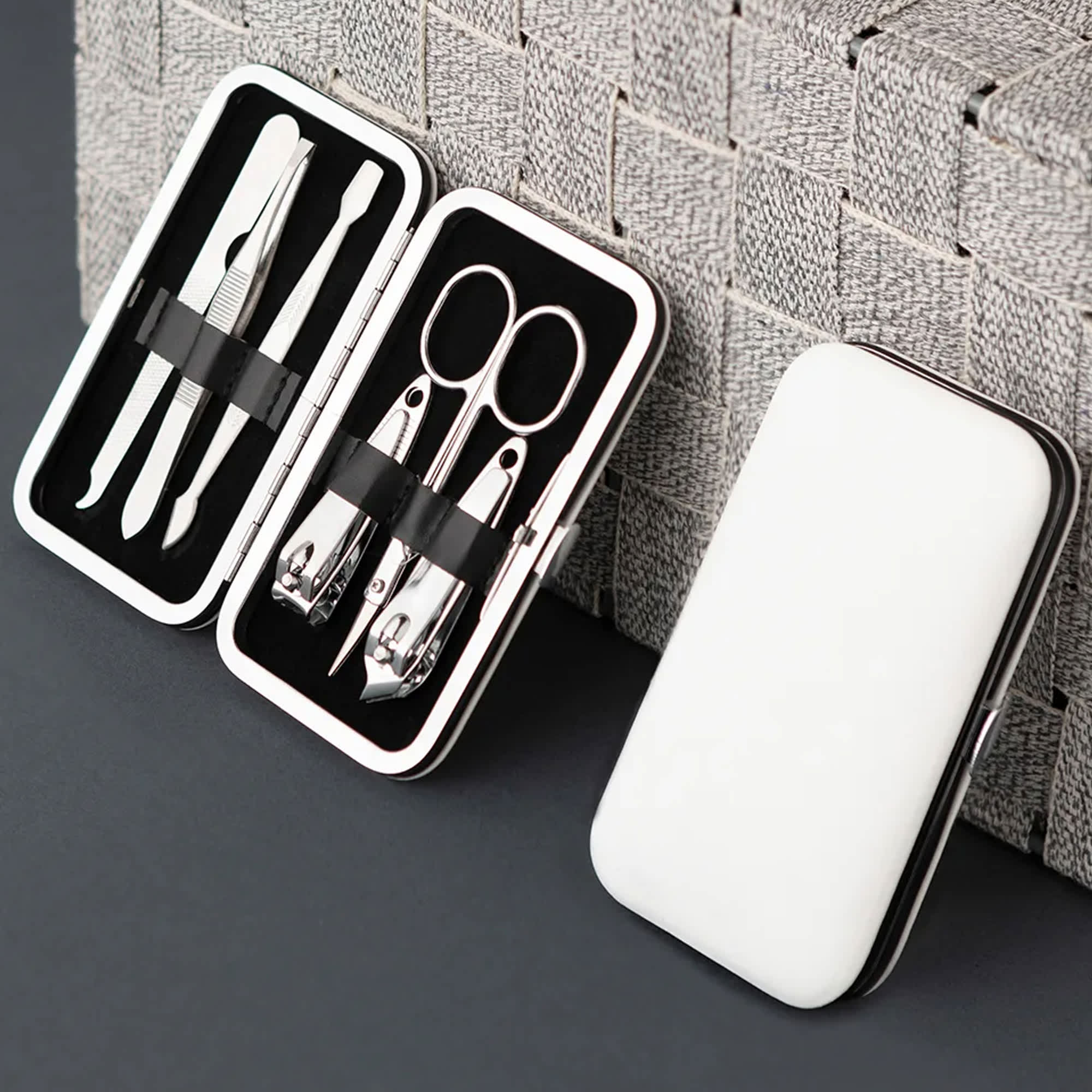 A sleek white manicure set case containing stainless steel tools like scissors, clippers, and tweezers. Zoel Manicure Set - Image 1