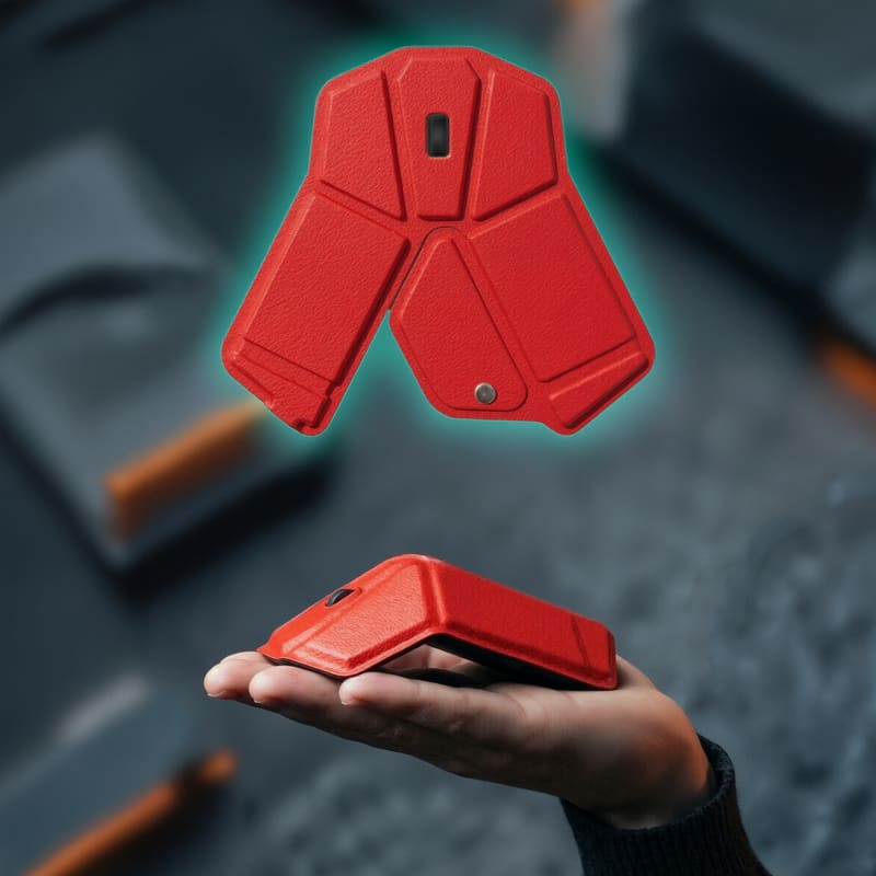 A red foldable wireless mouse resting in a hand, showcasing its compact design and modern aesthetics. Stealth Foldable Wireless Mouse - Image 1