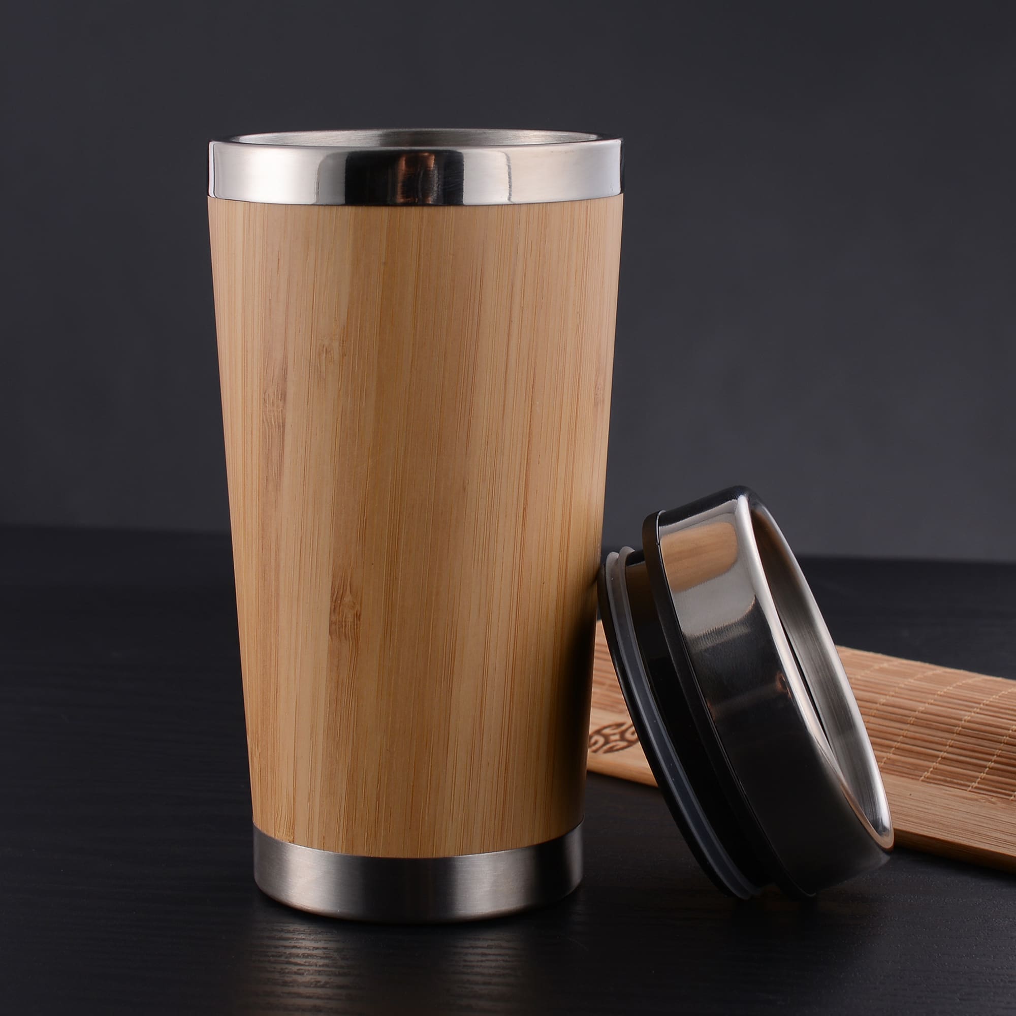 A bamboo reusable coffee mug with a stainless steel base and lid, showcasing a natural wood finish. Jackson Bamboo Mug - Image 1