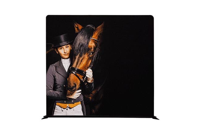 A multi-purpose floor display featuring a person in equestrian attire with a horse, set against a black background. Multi Purpose Floor Display 2950mm x 2300mm Polyester Sleeve - Image 1