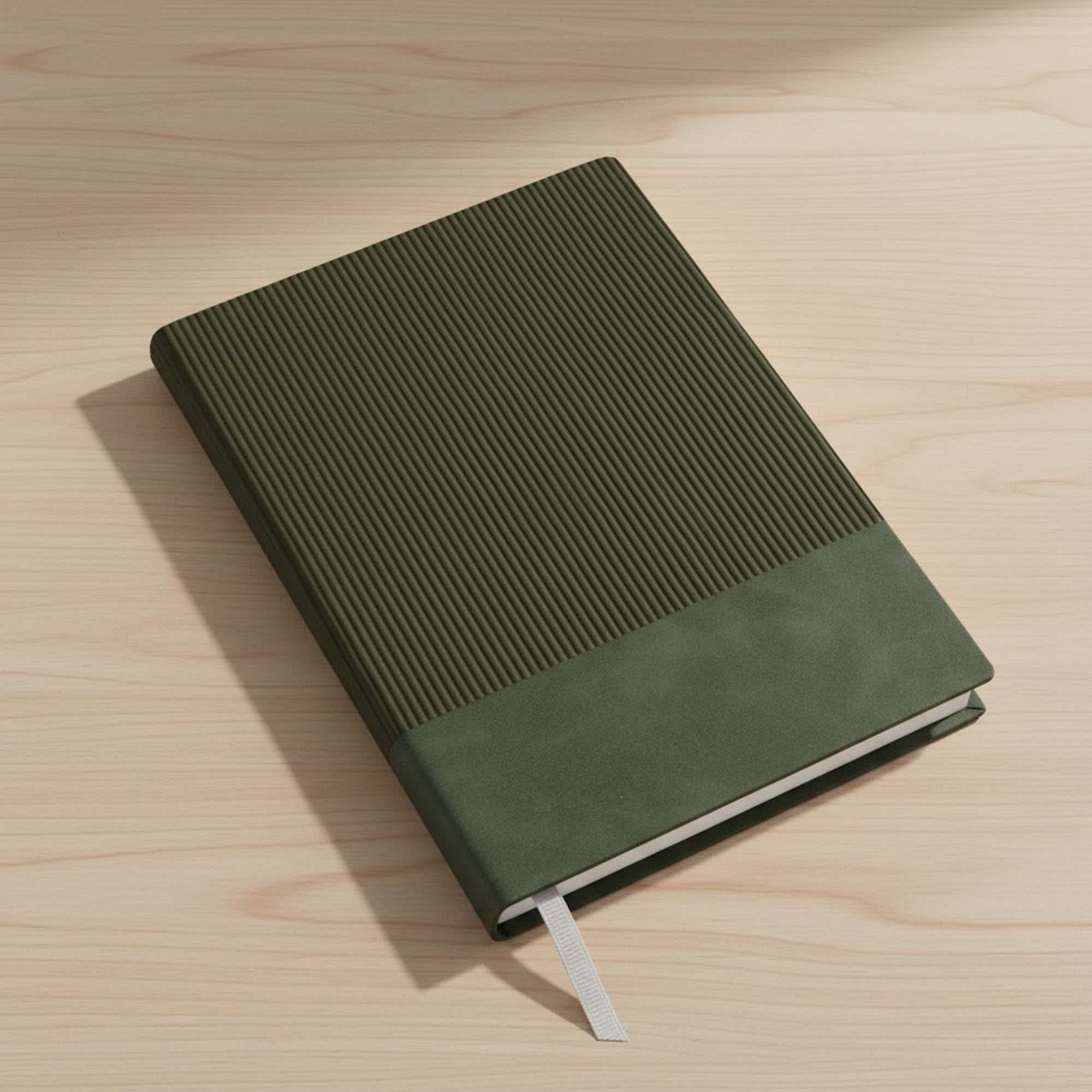 A black A5 notebook with a textured cover, resting on a wooden desk beside a window. Murica Notebook A5 - Image 1