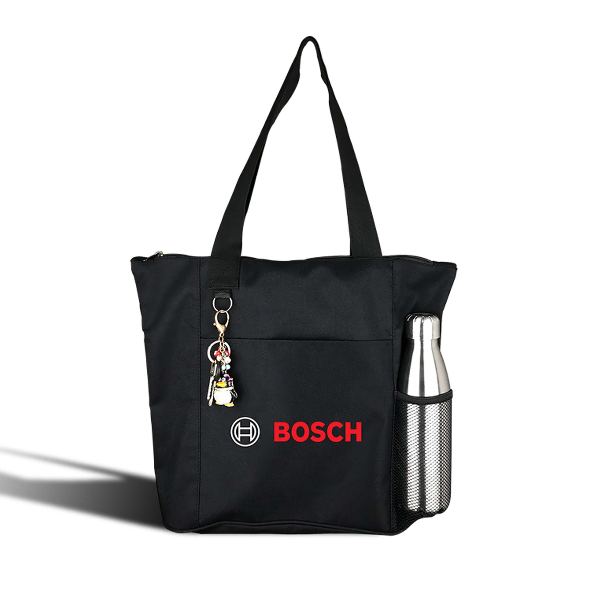 A black nylon shopping tote featuring a side pocket for a drink bottle and a keychain. It has a logo on the front. Karryall Nylon Shopping Tote - Image 1